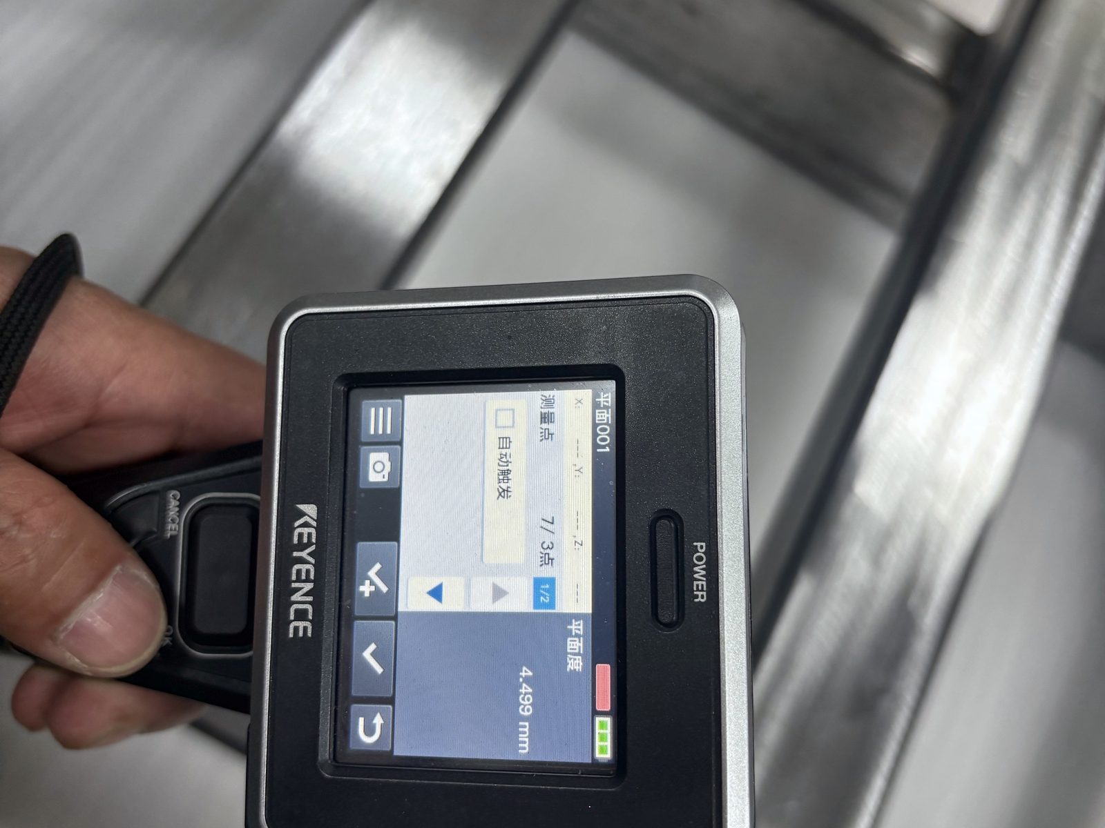 KEYENCE handheld measurement device showing a flatness readout on a welded frame at ACE Suzhou